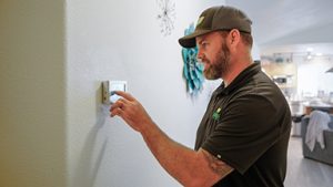 Mahalo-technician-working-on-smart-thermostat