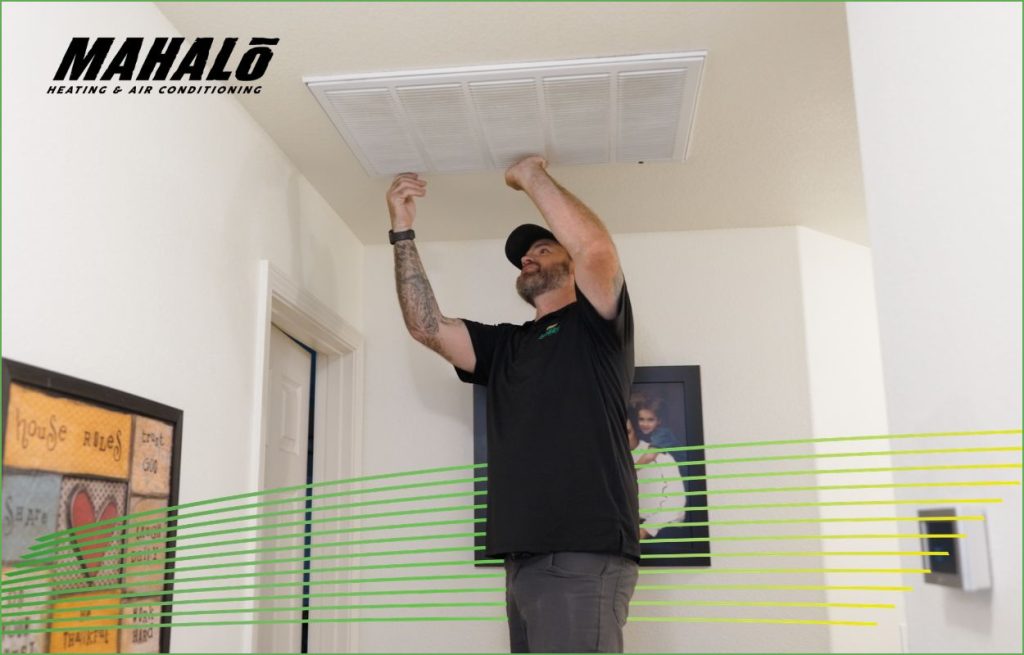 An HVAC technician replacing a air filter
