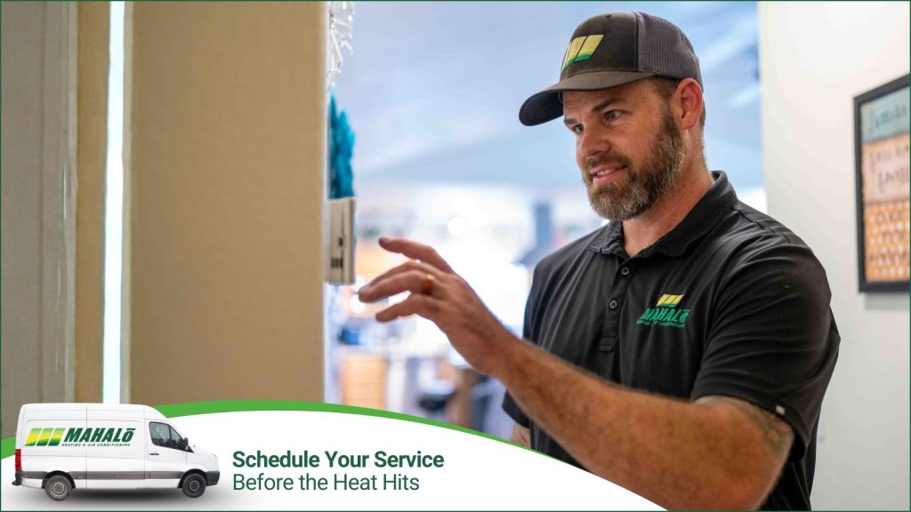 A HVAC tech adjusting a smart thermostat.