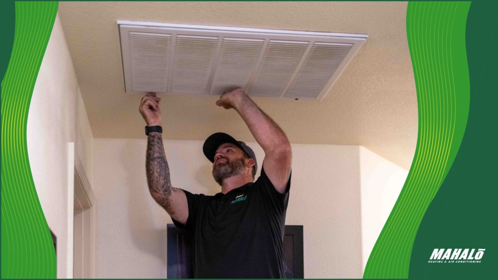 An HVAC tech checking for AC issues.