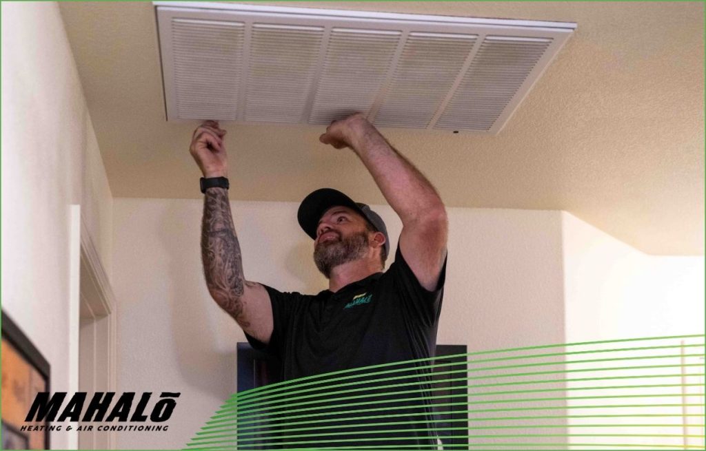 A Mahalo HVAC tech servicing an HVAC Unit